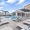 a pool in a courtyard with buildings in the background